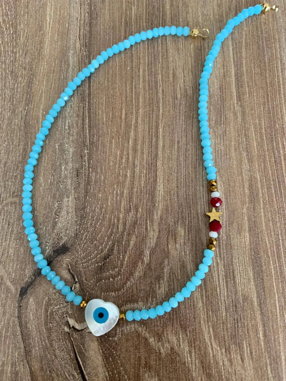 Crystal light blue with mother of pearl heart evil eye